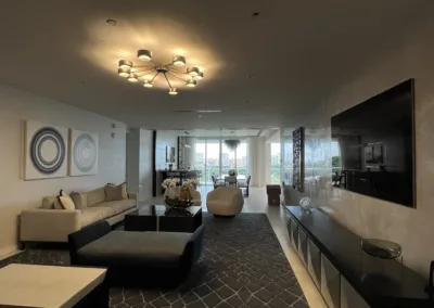A living room in a modern apartment with a chandelier.