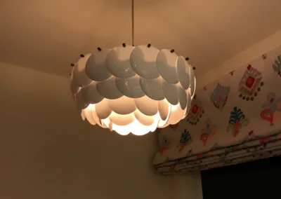 A white light fixture hanging in a room.